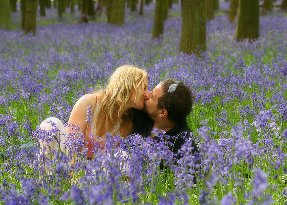 man-woman-kissing-bluebell-fields-woods