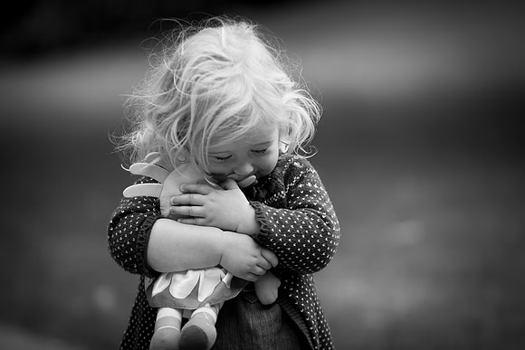 Little-girl-cuddling-teddy-toy