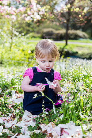 Little-girl-playing-flowers-park