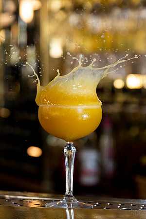 Cocktail splash wine glass on bar