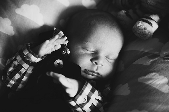 Portrait of sleeping newborn baby black and white