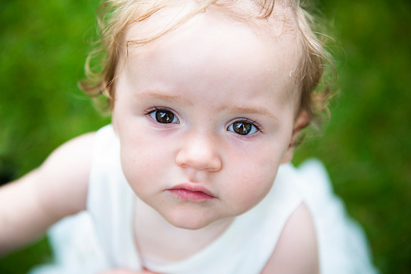 Portrait of baby girl in dress on the grass