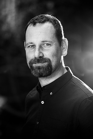 Formal staff portrait in black and white